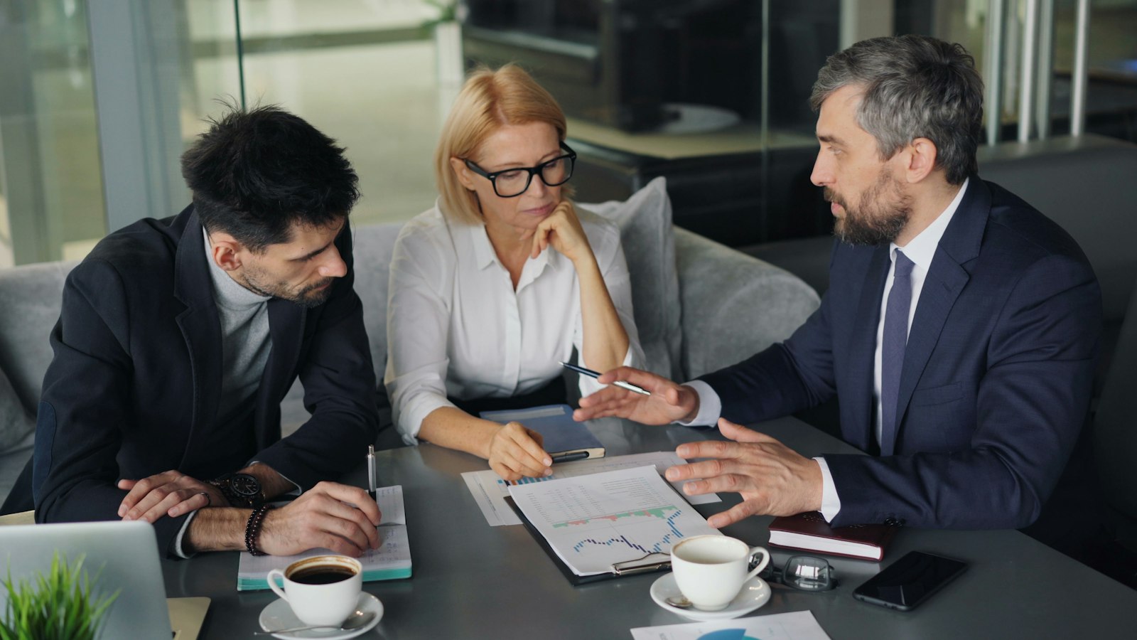 Executives reviewing rebate performance charts